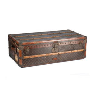 A Louis Vuitton Cabin Trunk: Early 20th Century. Having a monogrammed canvas exterior. Stenciled "C.D.B." with original brass fittings, Louis Vuitton lock, and leather handles. Height: 13 1/4" Width: 29 3/4" Depth: 39 1/2"