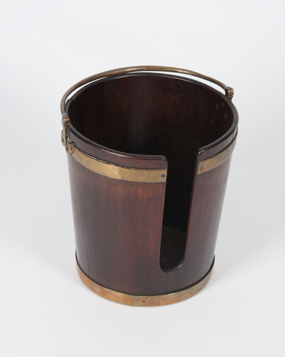 A 19th C George III Mahogany Plate Bucket: With brass binding and brass swinging handle. Seperation to side boards. Height: 15 1/2" Diameter: 14 3/4"
