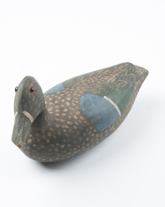 A Teal Hen Duck Decoy: Unsigned. Label to underside reads 'Alfred Hebert or Earl Brunet 1970s'. Beak damaged. Height: 5" Length: 10 1/2"