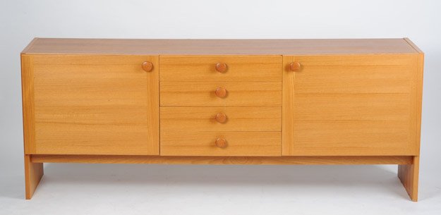 Danish Modern Teak Credenza: Having a column of four drawers flanked on each side by single door. Possibly Soburg Mobler. Marked STM-65 to back. Height: 28 1/2" Width: 73 3/4" Depth: 17 1/4"
