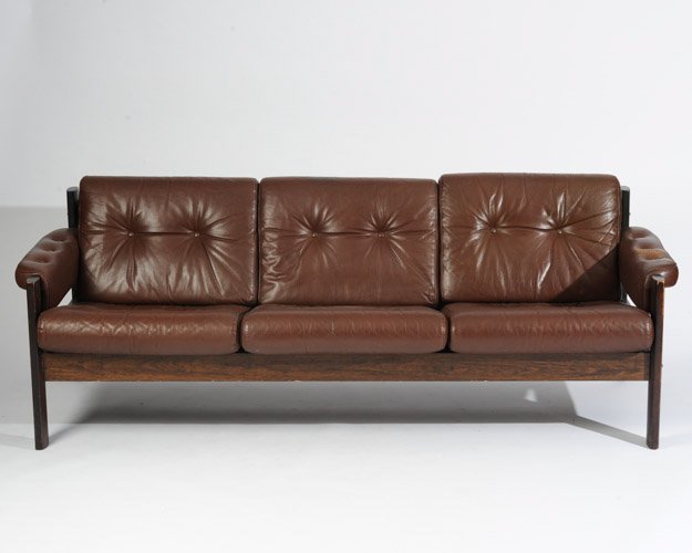 Rosewood & Brown Leather Sofa, Denmark: Three cushion. Length: 79" Height: 28"Wear to leather on armrest.