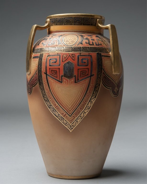 Nippon Hand-Painted Handled Vase: Having geometric Art Nouveau pattern in gold, black, and red-brown, with flower medallions. Height: 8 1/2"