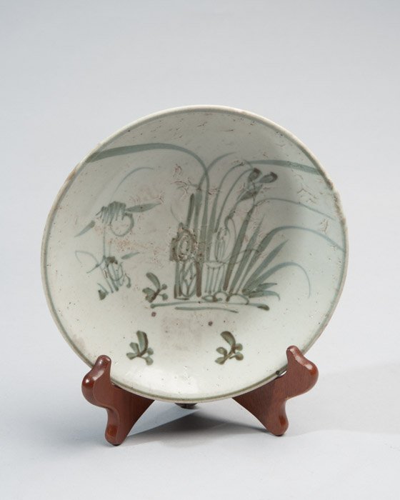 A Very Early Anemese (Vietnamese) Glazed Bowl: Possibly 12th/13th C, an early form of celadon with floral and reeds designs. Diameter: 7"