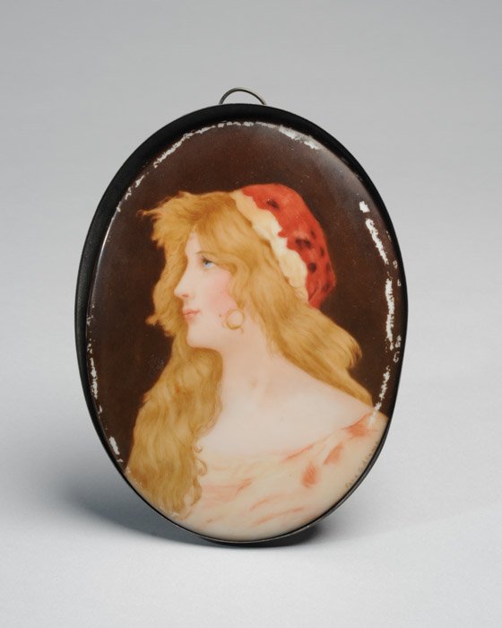 A Continental Hand-Painted Porcelain Plaque: Oval and marked to the back MHR, the subject is a young blonde woman with red hat and gold earrings. Signed lower right Sara G. Adams. Frame scrapes to edges. 7 3/4" high, 5 3/4" wide.
