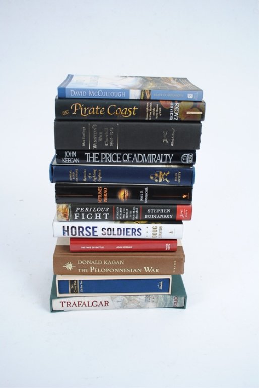 Assortment of Twelve (12) Military Theme Books: Twelve books including "Horse Soldiers" by Doug Stanton, "The Price of Admiralty" by John Keegan, "Brave Companions" by David McCullough, "Neptune's Inferno" by James Hornfischer, "The Pirate Coast" b