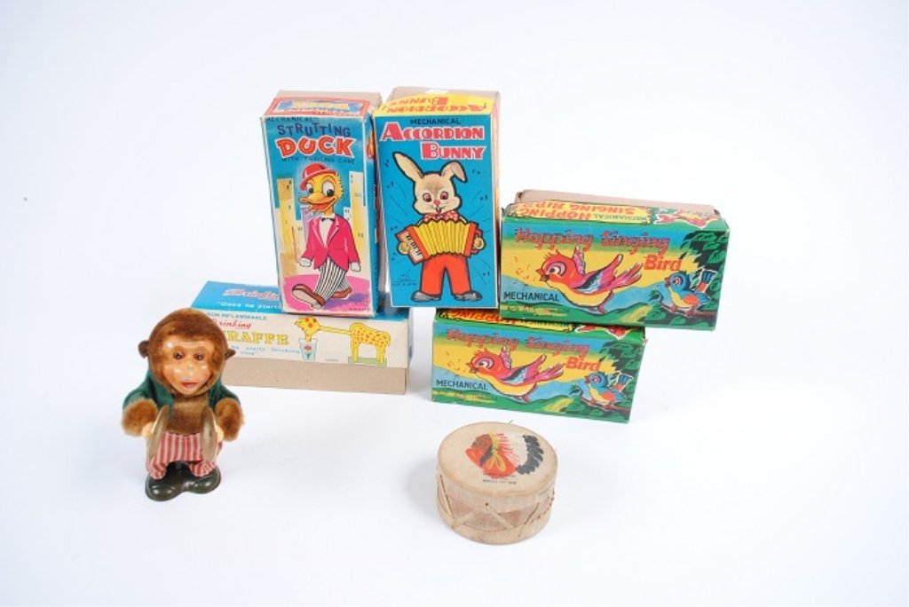 Lot of Seven (7) Vintage Toys: Includes two mechanical hopping singing birds, a mechanical strutting duck, a mechanical accordion bunny, a drinking giraffe, a wind up monkey that plays symbols and a World's Fair drum.