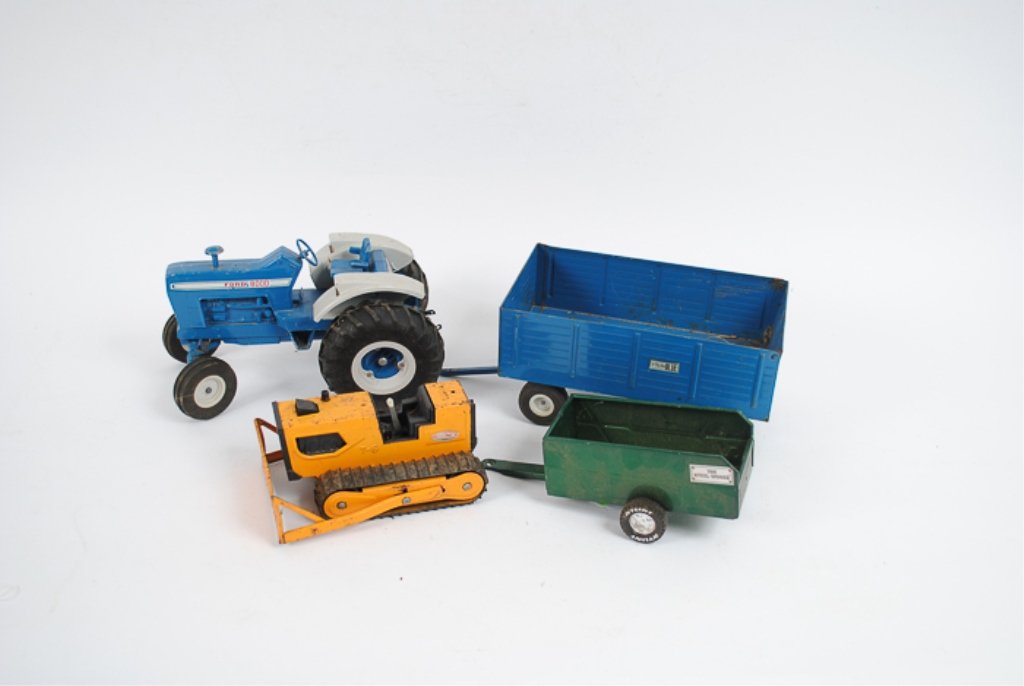 Ford 8000 Toy Tractor Trailer and Tonka T-6: Includes a yellow Tonka T-6, a blue 8000 Ford tractor trailer as well as a Nylint green The Steel Works trailer; both are metal; back of Ford tractor trailer flips up.