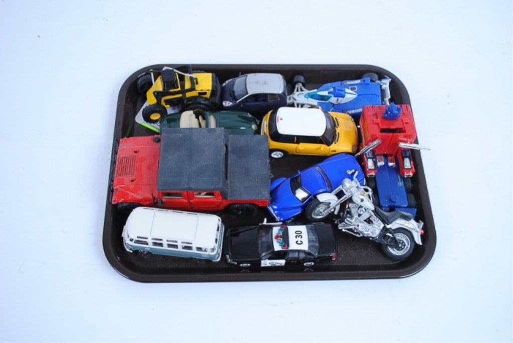 Lot of Eleven (11) Toy Cars: Includes an Optimus Prime Transformer, a Maisto Hummer, a Volkswagen Van Samba, a Maisto Harley Davidson, a Tonka Mighty 728, a Maisto 2000 Chevrolet SSR, a Ford Interceptor Patrol car, a Jaguar E. Ca