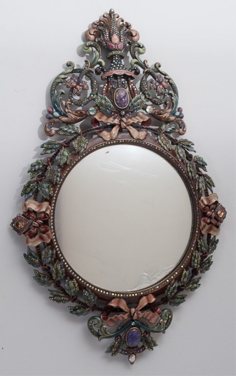 Jay Strongwater French Baroque Style Wall Mirror: Jay Strongwater French Baroque style wall mirror approximately 22-3/4" x 14-1/2", with a 9-1/4" diameter mirror inset, and with polychrome enamels and colored Swarovski crystals inset in the metal fra