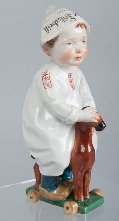 Meissen Porcelain Hentschel Boy: Glazed porcelain boy riding toy horse; Meissen crossed swords mark on bottom along with "W120" and "118"; approximately 7" tall; designed by Konrad Hentschel; excellent condition.