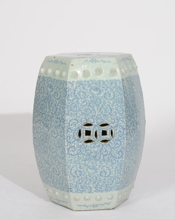 A Chinese Blue & White Porcelain Garden Seat: Six sided with a pierced top and an allover underglaze blue floral and vining design. 20" high, 14" diameter.