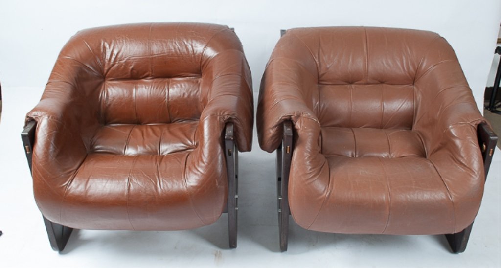 Pair of "Percival Lafer" Chairs: Mid-Century modern; made in Brazil; 1968; brown leather upholstery; each measures approximately 27-1/2" tall, 31" wide from arm to arm, and 20" deep from back of seat to front; teakwood frame; apparen