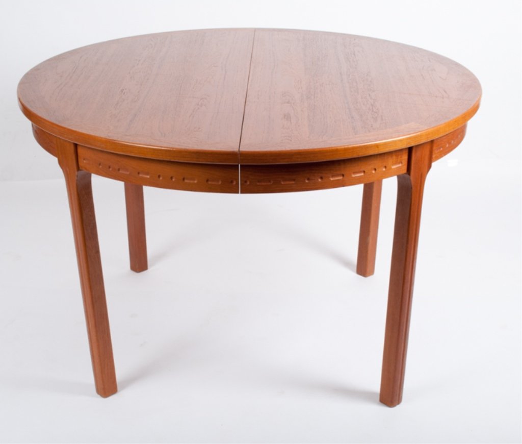 Nils Jonsson Teakwood Dining Table: With self-contained leaves; measuring approximately 28-3/4" tall and 45-1/4" in diameter; interesting dash and dot pattern along edge of table.