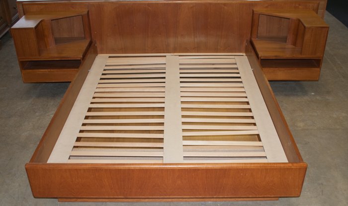 Mid-Century Queen Size Bed: With bookshelf ends; measures approximately 24-1/2" tall, and 114-1/2" wide; end bookshelves measure approximately 21" tall, 23-1/2" wide, and 20" deep; each has several cubbies, a pull out surface, a