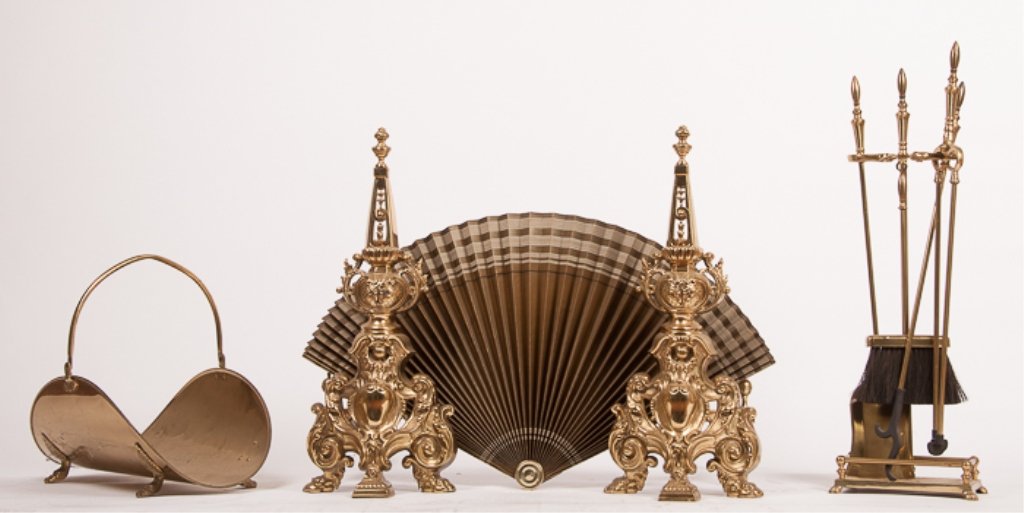 Pair of Victorian Andirons and Fireplace Tools: Highly decorated brass andirons measure approximately 25-1/2" tall; includes a standing fireplace tool set as well as a large fan and a brass wood tote with handle.