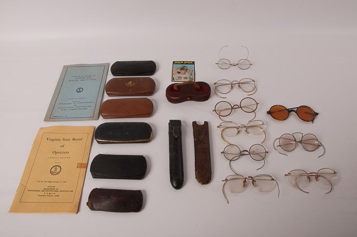 Collection of Nine (9) Vintage Eyeglasses: Includes nine eyeglass cases, a 1970 "Virginia State Board of Opticians Annual Roster", a "Virginia Board of Hearing Aid Dealers and Fitters Roster of Licenses" and a Ken Brett baseball card; several