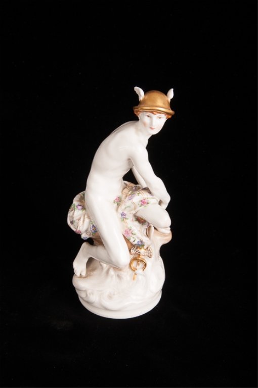 KPM Porcelain Figure Depicting Mercury: Gilded hat and caduceus and delicately detailed floral draping and facial features; in very good condition with no chips or cracks; measures approximately 8" tall; orange KPM symbol, cobalt blue scept