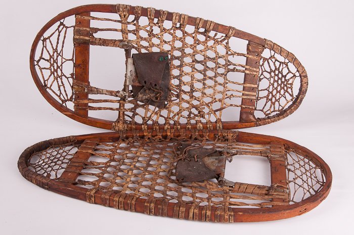 Pair of WWII Era Snow Shoes: Stamped on one "U.S. The Groswold Ski Co. Inc./ 9678-1945/ 73-28" and stamped on the other "U.S. C.A. Lund Hastings, Minn"; each measures approximately 28" long and 12-1/4" wide at widest point; in go