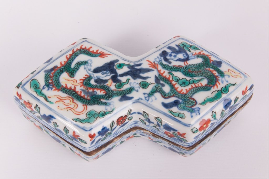 Chinese Doucai Decorated Box with Lid: Chinese porcelain box in a conjoined lozenge form with Doucai enamel decoration; apocryphal Ming Dynasty mark to base; measures approximately 2-1/2" tall with lid on, 8" wide, and 4" deep at deepest p