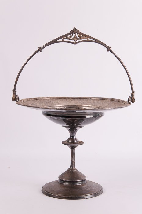 Meriden Silver Plated Pedestal Dish w/ Handle: Meriden silver plated pedestal dish with handle and ornate etchings along rim; bottom reads "Meriden B. Company" surrounding a set of scales as well as "1773" underneath; measures approximately 8" tal