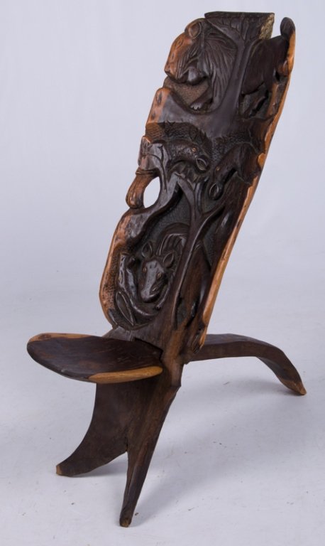African Birthing Chair: African birthing chair featuring carved animal depictions throughout with a lion to the top; measures approximately 33-1/2" tall to top of back, 13" tall to top of seat, 9-1/2" wide and deep seat, and