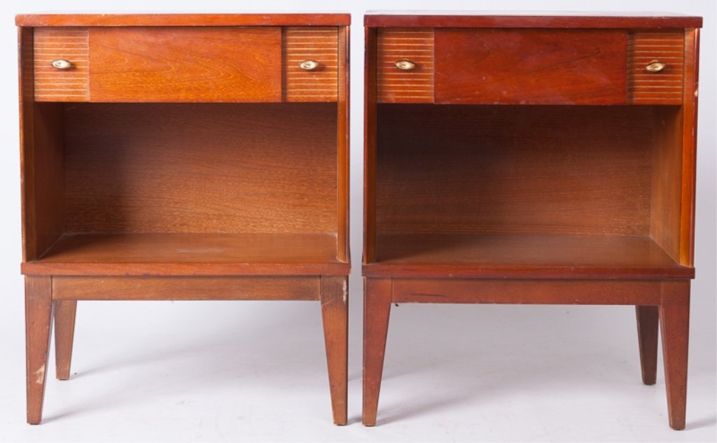 Mid-Century Nightstands, Pair: Pair of mid-century nightstands; each features one drawer with a shelf underneath as well as brass knobs and tapered legs; Art Deco style drawer face has raised middle piece and carved linear accents 