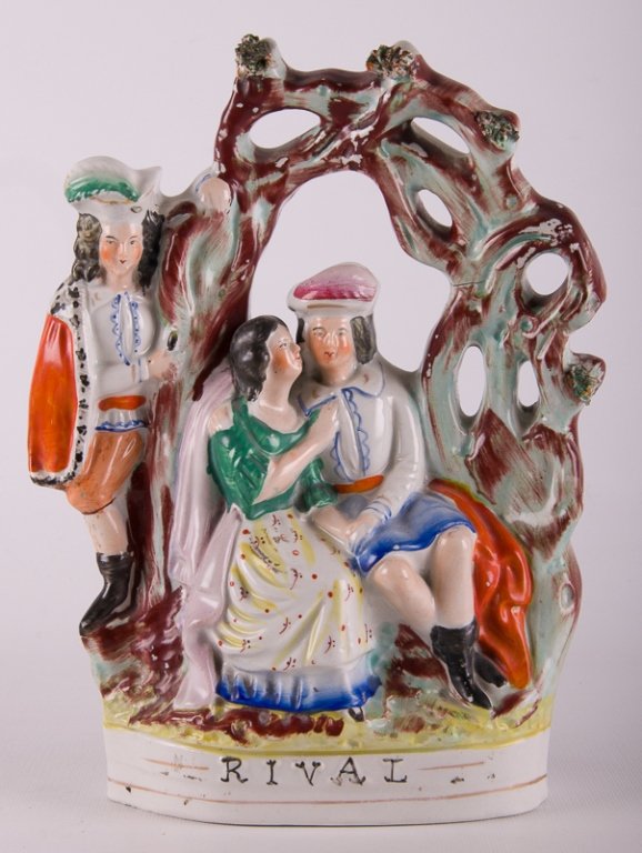 Staffordshire "Rival" Figurine: 19th century handpainted over glaze, Staffordshire figurine group under an arbor; titled "RIVAL" to bottom of front. Measures approximately 5-3/4" tall, 9-7/8" wide, and 7-3/8" deep. Hairlines through