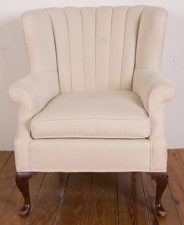 Cream Upholstered Wingback Armchair: Upholstered wingback armchair with a faint repeating triangle pattern against a cream background; on wooden cabriole legs and pad feet; measures approximately 37-1/2" tall to top of back, 19" tall to 