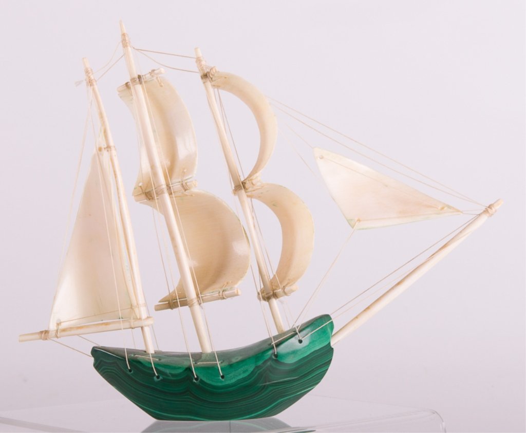 Malachite Sailboat Sculpture: Malachite sailboat with bone sails and masts; measures approximately 7-1/4" tall, 2" wide and 8-3/4" long; in Good condition with no apparent damage.