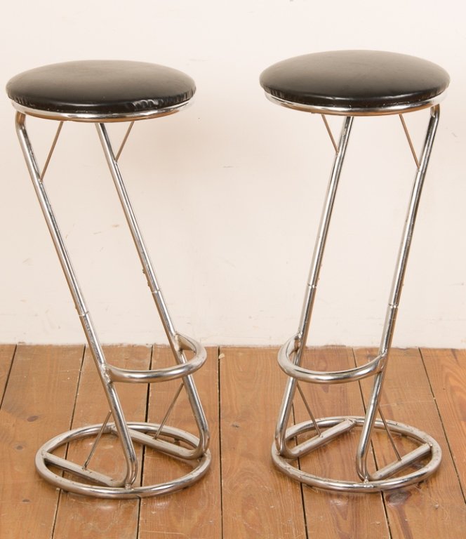 Mid-Century Chrome Bar Stools, Pair: Pair of mid-century chrome bar stools with black leather upholstered seats; each measures approximately 27-1/2" tall and 13" in diameter to base; both in Good condition with slight wear throughout.