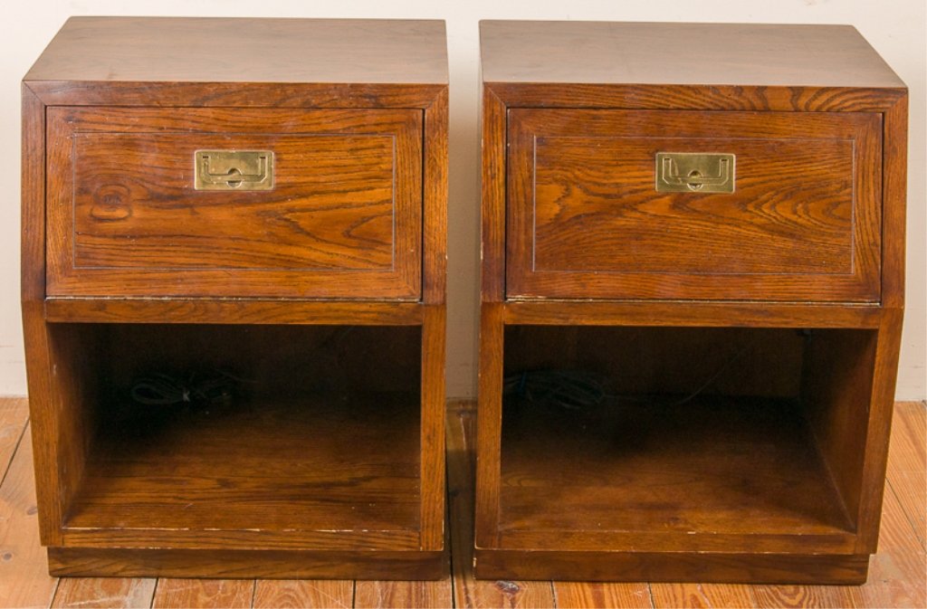 Henredon Campaign Style Nightstand Pair: Pair of Henredon campaign style walnut nightstands; each with a bottom cubby and a fold down cabinet housing a cubby; with brass handles; each measures approximately 28" tall, 22" wide, and 18" deep; 