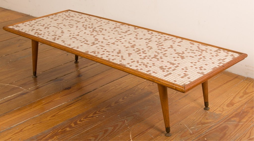 Mid-Century Tile-Top Coffee Table: Mid-century coffee table with brown and white tile work to top and wooden frame; features slant legs with brass tipped feet; measures approximately 12" high, 19-3/4" wide, and 50" long; in Good condit