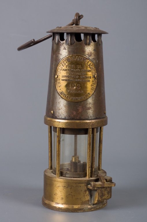 Protector Lamp & Lightning Co Ltd. Miner's Lamp: The Protector Lamp & Lighting Co. Ltd brass miner's safety lamp with Pyrex glass; measures approximately 13-1/4" tall (with hook) and 3-3/8" in diameter to base; in Fair overall condition with age app