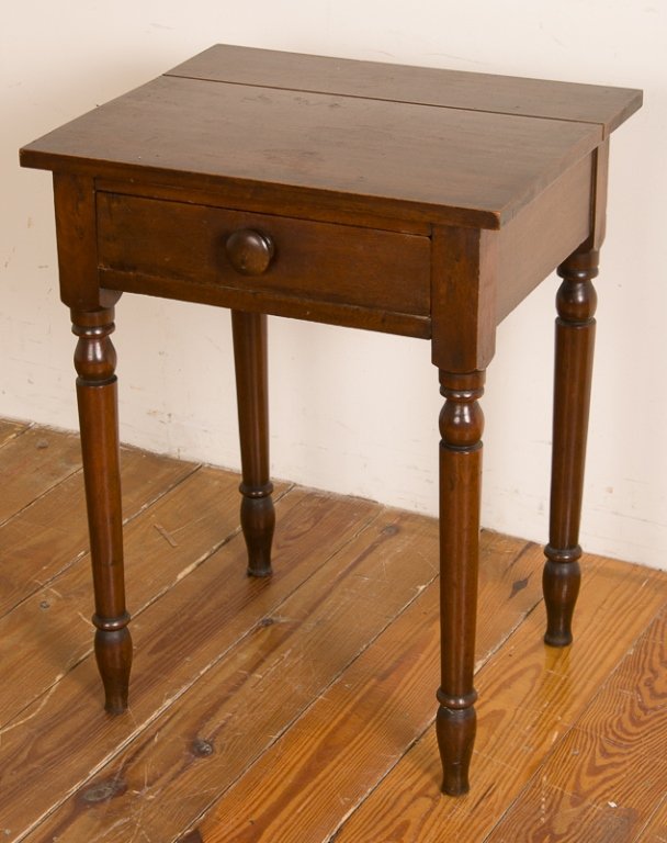 American Walnut Nightstand, Circa 1830: Circa 1830, American walnut one-drawer nightstand with turned legs; measures approximately 26-1/8" tall, 20-5/16" wide, and 17-7/8" deep; in Good overall condition with age appropriate wear and split 