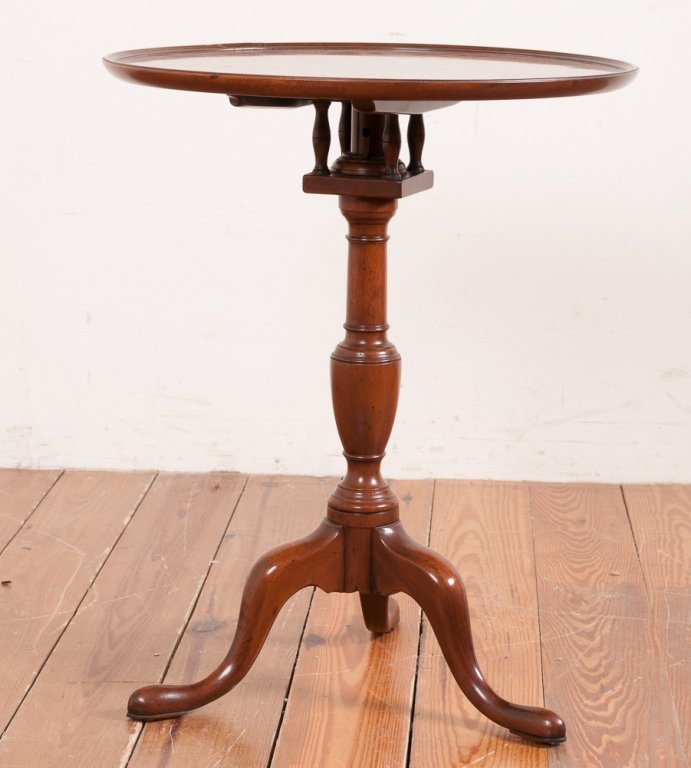 Kittinger Piecrust Pedestal Birdcage Table: CW 11 Colonial Williamsburg tilt-top table; appears to be walnut; bearing Williamsburg signature and labeled underneath; with tripod feet; measures approximately 27" tall and 21-3/4" in diameter; in G