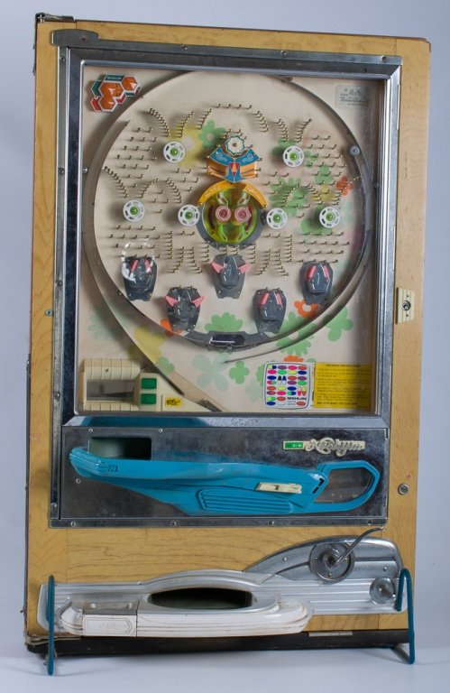 Pachinko Machine by Nishijin: Measures approximately 32" high, 20-1/2" wide and 7" deep at the bottom; in Poor condition with broken battery casing and wear throughout; includes at least 30 balls.