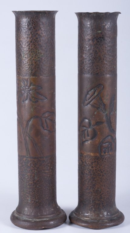 Trench Art Vases, Pair: Each with floral depictions to center banding; each measures approximately 13-3/4" tall and 3" in diameter to opening; both in good overall condition with some damage to top rim of one.