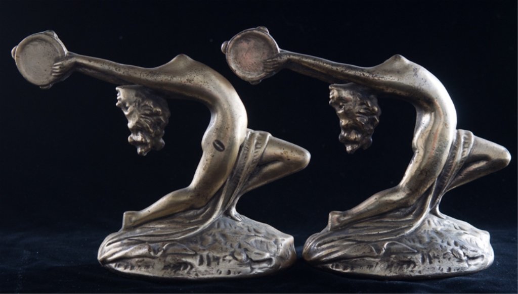 Armor Bronze Art Deco Bookends, Nude Female: Armor Bronze bookends of nude female with a tambourine; labeled to bottom of each and marked and dated 1927 to side; measures approximately 7" tall and 9" long; in good overall condition.