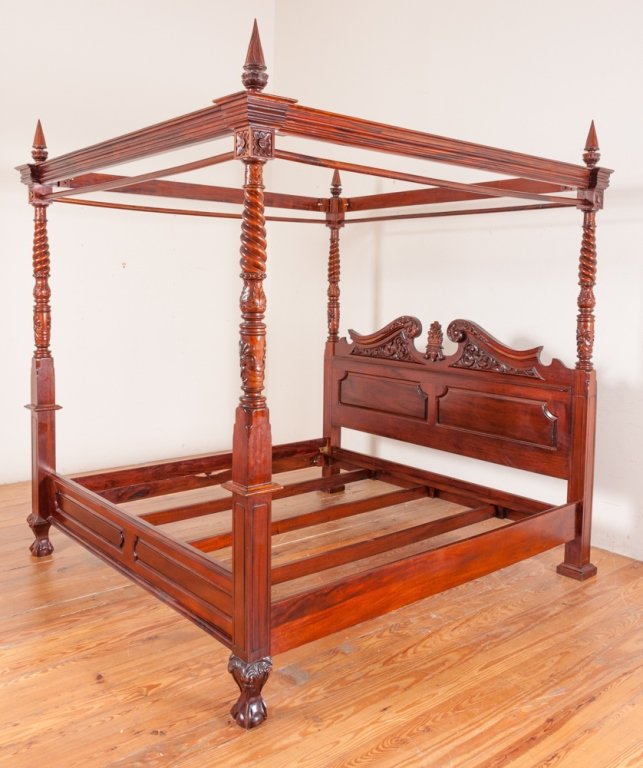 King Size Canopy Bed: King size canopy poster bed with carved open crest and paneled headboard, footboard ending in claw and ball feet, and four block, carved and spiral column posts with flambeau finials; measures approxi