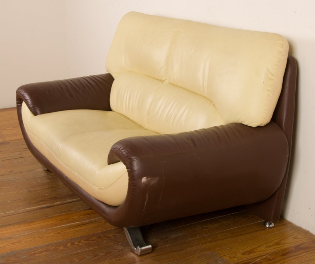 Leather Two-Toned Contemporary Loveseat: Leather loveseat; beige with brown frame; curved design to front edge and arms; measures approximately 35-1/2" tall to top of back cushion, 15-1/2" tall to top of seat, 63" wide arm to arm, and 20-1/2