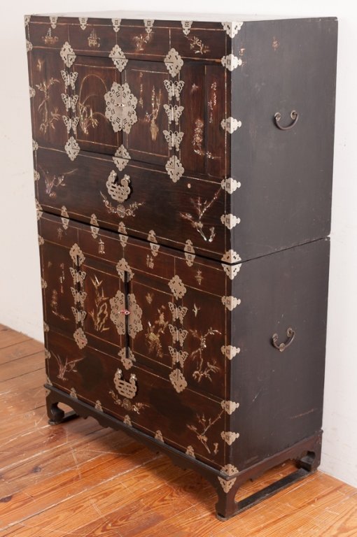 Asian Cabinet in Two Parts: Asian cabinet in two parts of exotic hardwoods, beautifully inlaid with mother of pearl having butterfly hinges and pierced metal mountings; measures approximately 52-5/8" high, 34" wide and 15-3/4" i