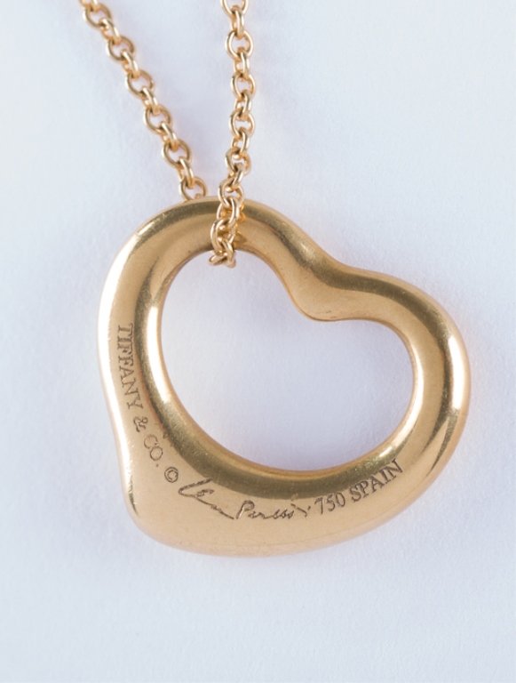 Elsa Peretti Tiffany & Co. 18K Yellow Gold Necklace: Elsa Peretti 18K Necklace for Tiffany & Co.- a small floating heart on a fine link chain, marked to the clasp and to pendant; measures approximately 16" long. Weighs approximately 4.4 grams.