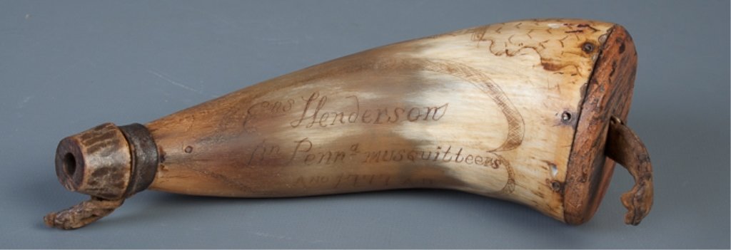 Scrimshaw Powder Horn Circa 1777 Philadelphia: Scrimshaw powder horn of bovine hoof with wood plug and pouring spout, and leather loops for strap. Inscribed "Philadelphia" with a city and harbor scene and "Ens. Henderson Bn. Penna. Musquitteers An