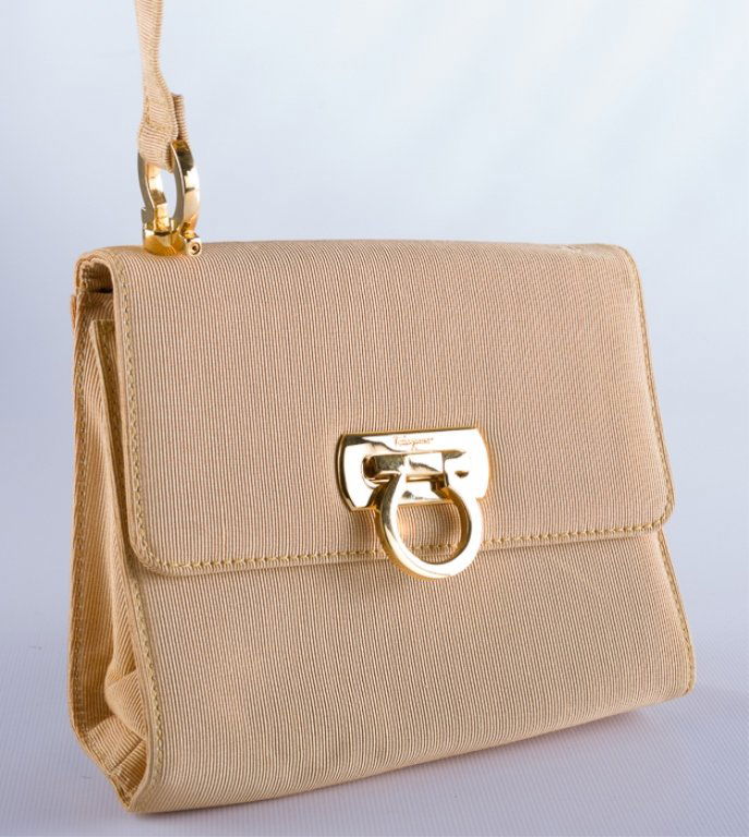 Salvatore Ferragamo Crossbody Evening Bag: Gold in hue of fabric as well as hardware, complete with original Salvatore Ferragamo label to inside stating "BA214797 Made in Italy" as well as "Made In Italy" stamped to inside on clasp hardware. C