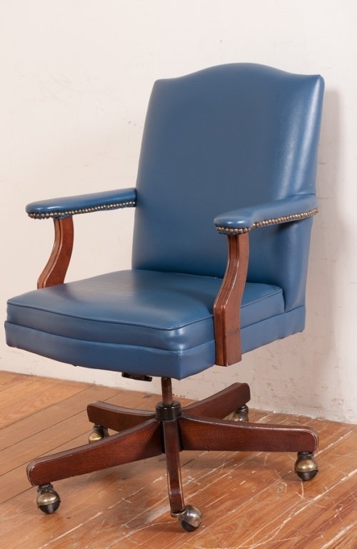 Executive Office Chair On Castors: Rolling office desk armchair with leatherette upholstery and nail head accents; measure approximately 38-1/2" high, 36-3/4" wide with a seat depth of 18-1/2" and seat height of 19-1/2. Marked "Made in