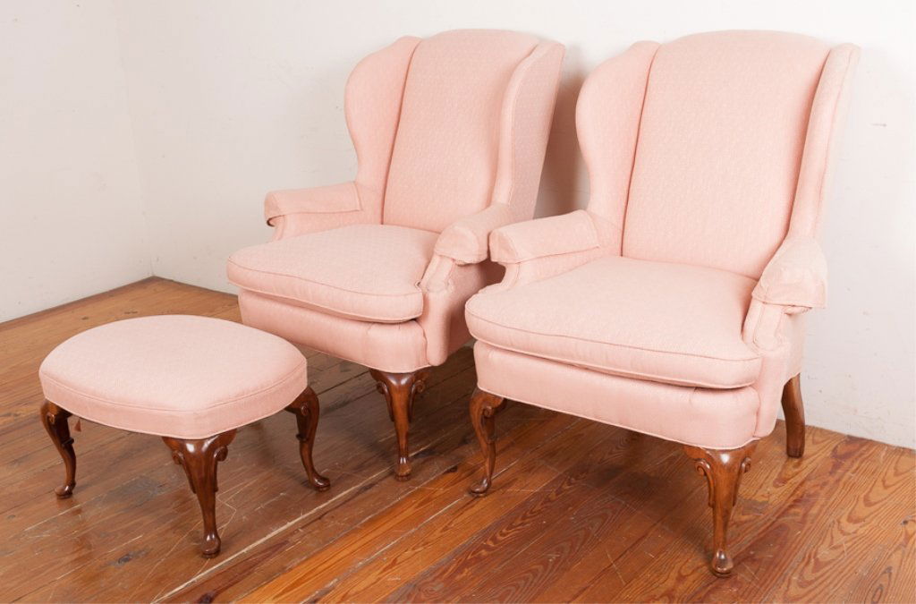 Michael Thomas Wingback Chairs w/ Ottoman: Pair of Michael Thomas Furniture Inc. upholstered wingback chairs having sloped panel arms, T-front cushions, arm cap covers and carved front legs with single matching ottoman; chairs measure approxim