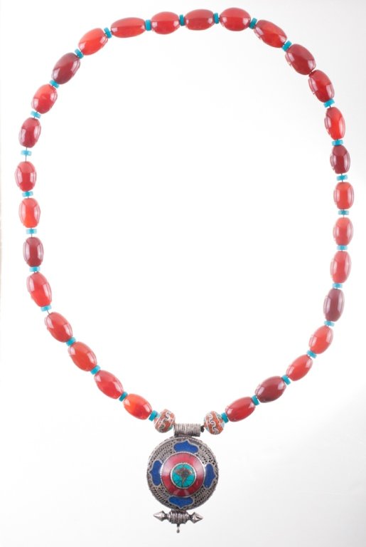 Carnelian, Turquoise, Coral and Silver Necklace: Necklace with twenty nine carnelian, twenty nine turquoise heishi beads, two silver inlay beads and a silver inlay pendant. Pendant measures 3” in length and 2” in width. Necklace measures 31” i