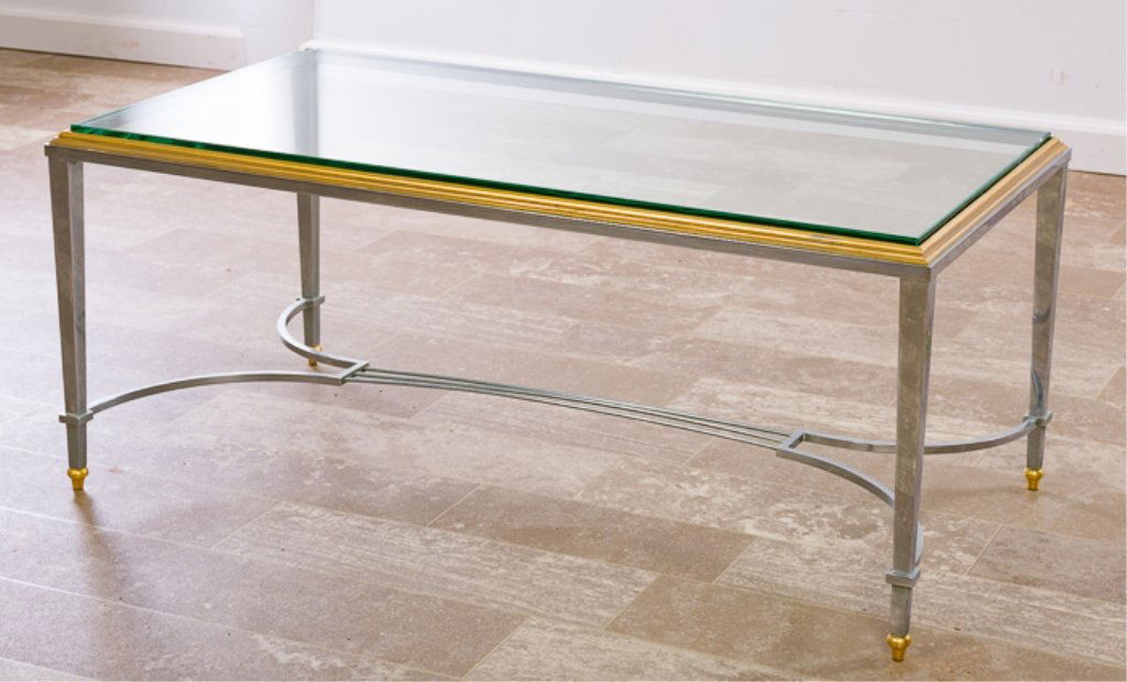 Maison Jansen Style Coffee Table, Glass Top: Neoclassical Style two toned coffee table attributed to Maison Jansen with gold and chrome colored finish and having a 3/4" glass top; measures approximately 15-1/4" high, 19" wide and 36" in length.