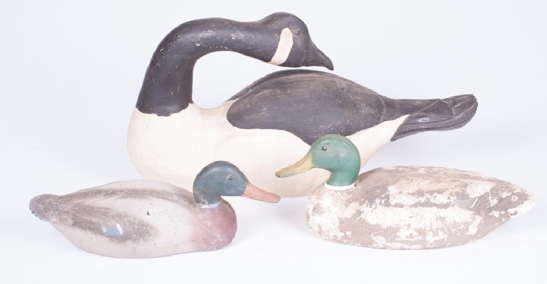 Victor & Ellis Simon Duck, & Goose Decoy Trio: Three waterfowl decoys to include: one Canada goose, hand painted with head turned across back; measures 11-3/4" high, 8" wide and 23" long. One modern molded plastic working duck; measures 5-1/2" hig