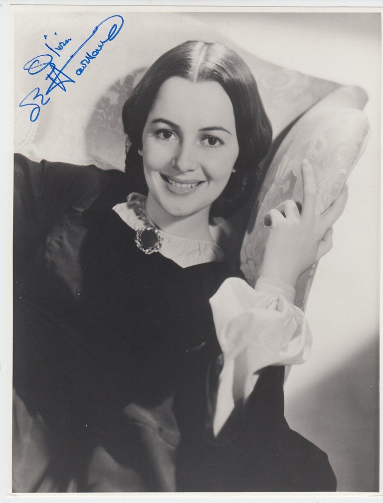 Olivia de HAVILLAND American actress native from Great: Olivia de HAVILLAND American actress native from Great Britain (born 1916). Signed photograph, 9.8x7.7 inches; [August 22, 1971, London]. In black & white. In the movie Gone with the wind. Very good c